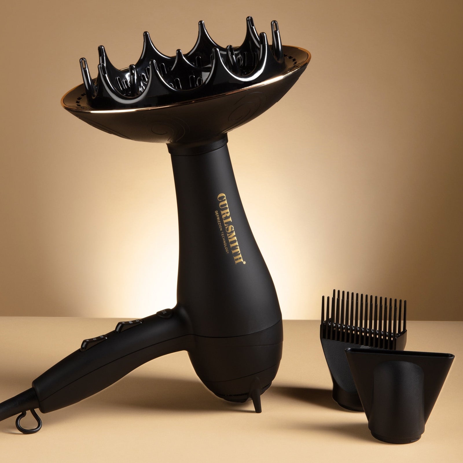Black hair dryer with attachments on a beige background