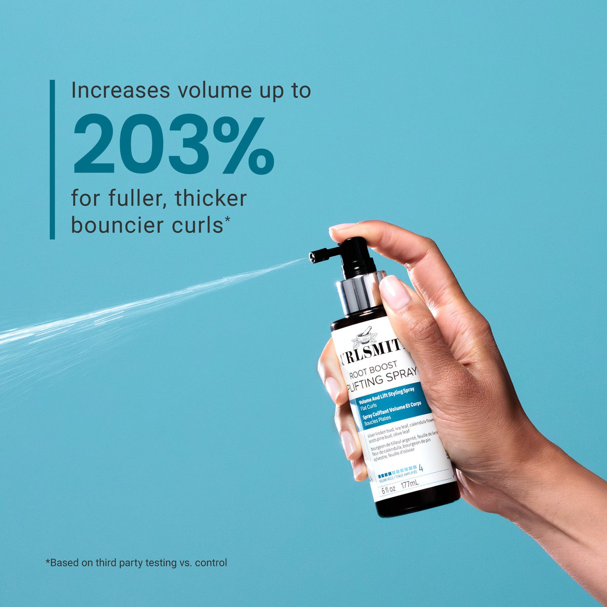 Hand holding a bottle of Root Boost Texturizing Spray against a blue background