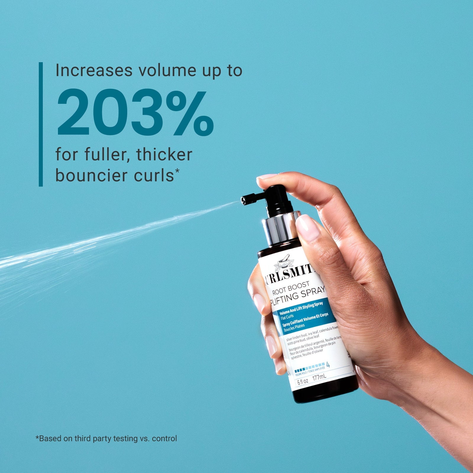 Hand holding a bottle of Root Boost Texturizing Spray against a blue background