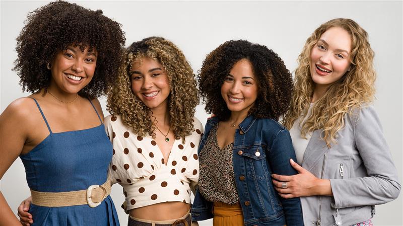 Diverse women with different curly hair types smiling