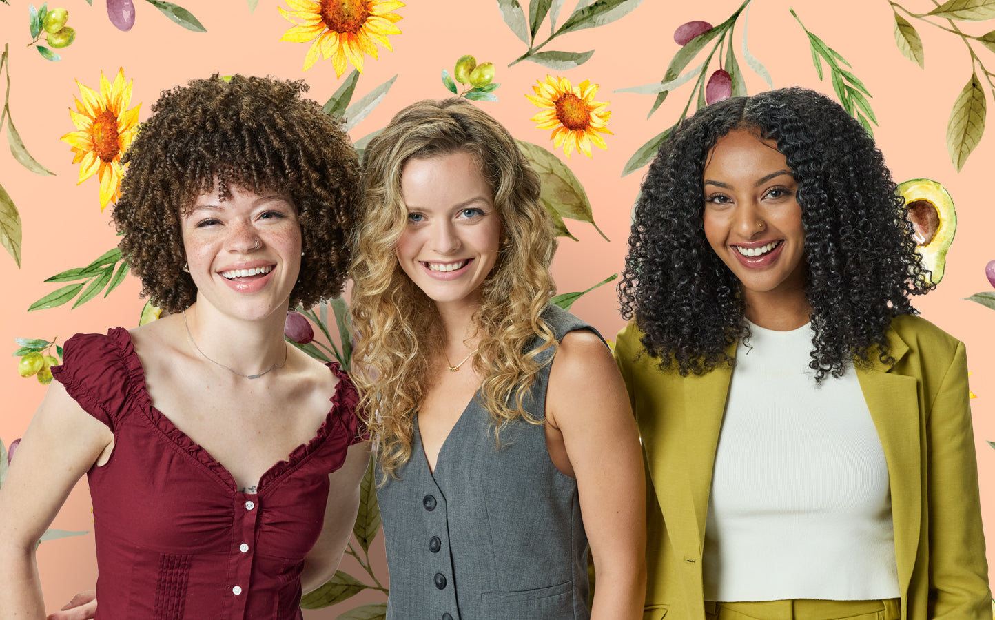 Three women standing together with a floral and fruit patterned background