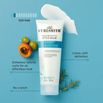 Curlsmith styling balm tube with ingredients on a blue background